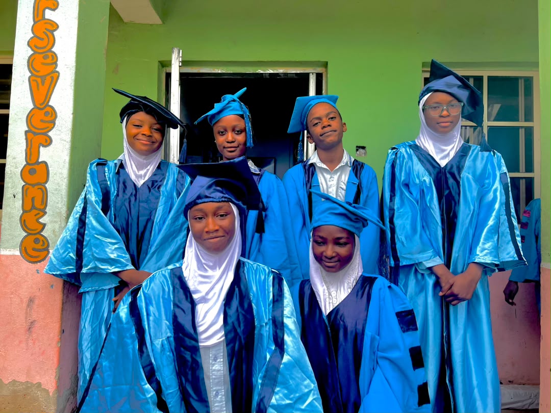 SFMS 2025/2026 graduands in blue gowns beside the school perseverance wall