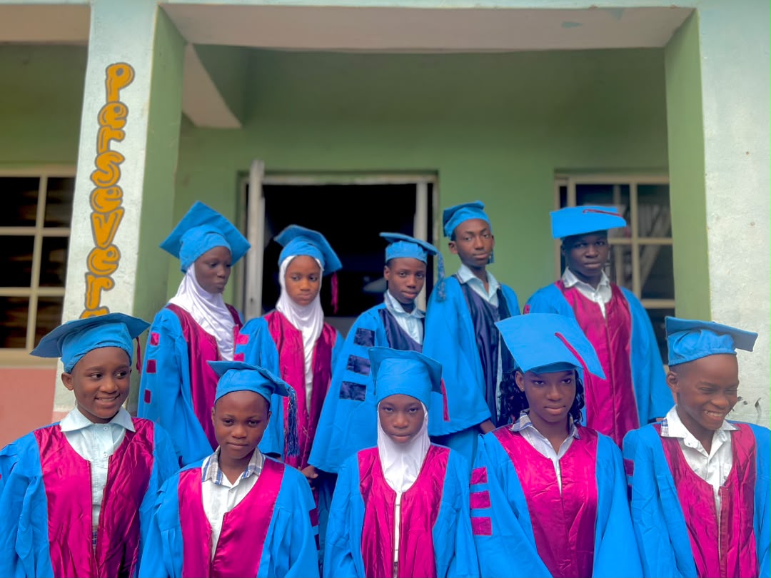 SFMS 2025/2026 graduands in blue and pink gowns on the school steps
